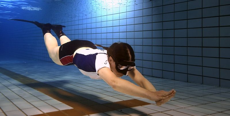 Спортсменка скользит над дном